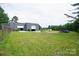 Exterior view of the building, surrounded by a large grassy area and multiple entry points at 1028 Washburn Switch Rd, Shelby, NC 28150