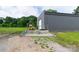 Side view of a gray building with a loading dock and a forklift parked outside at 1028 Washburn Switch Rd, Shelby, NC 28150
