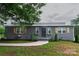 Charming home featuring a landscaped front yard, stone walkway, and decorative shutters at 1028 Washburn Switch Rd, Shelby, NC 28150