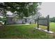 Charming gray brick home featuring a well-manicured lawn, shuttered windows, and inviting curb appeal at 1028 Washburn Switch Rd, Shelby, NC 28150