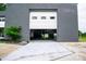 Bright garage featuring a partially open door, a car lift, and ample workspace at 1028 Washburn Switch Rd, Shelby, NC 28150