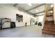 Spacious garage interior with high ceilings, a car, stairs, and ample workspace at 1028 Washburn Switch Rd, Shelby, NC 28150