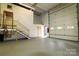 Large garage space with high ceilings, roll-up doors, and ample room for storage and projects at 1028 Washburn Switch Rd, Shelby, NC 28150