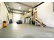 Spacious garage with high ceilings, car, stainless appliances, storage, stairs and roll up doors at 1028 Washburn Switch Rd, Shelby, NC 28150