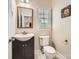 Cozy half bathroom featuring vanity with dark cabinets, and a decorative mirror at 1185 Willow Creek Dr, Newton, NC 28658