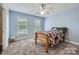 Blue bedroom featuring neutral carpet, ceiling fan and two bright windows at 1185 Willow Creek Dr, Newton, NC 28658