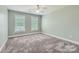 Bright bedroom featuring neutral walls, plush carpeting, a ceiling fan, and windows with blinds at 1185 Willow Creek Dr, Newton, NC 28658