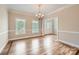 Formal dining room with hardwood floors, elegant lighting, and decorative molding, ideal for Gathering gatherings at 1185 Willow Creek Dr, Newton, NC 28658