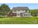 Back exterior view of a brick and siding home with a sunroom and a spacious backyard at 1185 Willow Creek Dr, Newton, NC 28658
