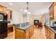 Open kitchen with granite countertops, wood cabinets, and an island with pendant lighting at 1185 Willow Creek Dr, Newton, NC 28658