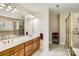 Main bathroom with dual vanities, glass shower, and separate tub with tile surround at 1185 Willow Creek Dr, Newton, NC 28658