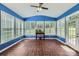 Bright sunroom with blue walls, tile floor, windows with blinds, and a ceiling fan at 1185 Willow Creek Dr, Newton, NC 28658