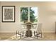 Bright dining area featuring a modern table, four chairs, large sliding glass door, and natural light at 130 Oconee Trl, Statesville, NC 28625