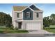 Charming two-story home showcasing blue accent siding, a two-car garage, and a well-manicured front lawn at 130 Oconee Trl, Statesville, NC 28625