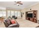 Cozy living room with a large leather sofa, entertainment center, and ample natural light at 1397 Tupelo Rd, Clover, SC 29710