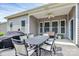 A covered patio with stylish outdoor seating and a ceiling fan for added comfort on warm days at 1397 Tupelo Rd, Clover, SC 29710