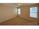 Cozy bedroom with neutral carpeting and sun-filled windows at 1423 Napa Nw St, Concord, NC 28027