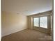 Bright bedroom featuring neutral walls, carpet flooring, and a window offering ample natural light at 1423 Napa Nw St, Concord, NC 28027