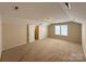 A spacious carpeted bedroom featuring a large window and ample natural light at 1423 Napa Nw St, Concord, NC 28027