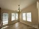 Bright dining area with large windows, hardwood floors, and stylish chandelier at 1423 Napa Nw St, Concord, NC 28027