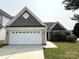 Charming home featuring a two-car garage, well-manicured lawn and mature landscaping at 1423 Napa Nw St, Concord, NC 28027