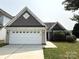 Charming single-story home with a well-manicured lawn and a two-car garage at 1423 Napa Nw St, Concord, NC 28027