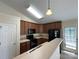 Functional kitchen featuring dark appliances and breakfast bar at 1423 Napa Nw St, Concord, NC 28027