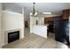 Open concept living area featuring a fireplace, hardwood floors, and adjacent eat-in kitchen at 1423 Napa Nw St, Concord, NC 28027
