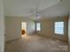Spacious main bedroom with neutral colors, vaulted ceiling, and natural light at 1423 Napa Nw St, Concord, NC 28027