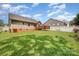 Spacious backyard featuring a wooden deck, lush green grass, and a charming privacy fence at 146 Pheasant Ridge Cir, York, SC 29745