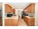 Modern kitchen with wooden cabinetry, stainless steel appliances, and a breakfast bar at 146 Pheasant Ridge Cir, York, SC 29745