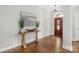 Bright foyer with hardwood floors, wooden table, and elegant front door entrance at 15024 Old Vermillion Dr, Huntersville, NC 28078