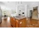 Bright and spacious kitchen island opens to the home's living area and staircase at 15024 Old Vermillion Dr, Huntersville, NC 28078