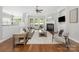 Bright living room with a fireplace, hardwood floors, and neutral decor at 15024 Old Vermillion Dr, Huntersville, NC 28078