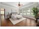 Inviting main bedroom with hardwood floors, a ceiling fan, and ample natural light at 15024 Old Vermillion Dr, Huntersville, NC 28078