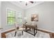 Cozy office space featuring two windows, a neutral rug, and a stylish desk with chair at 15024 Old Vermillion Dr, Huntersville, NC 28078