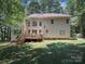 Back of home featuring a wooden deck, well-manicured lawn and mature trees at 155 Culpeze Rd, Mooresville, NC 28117
