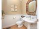 Powder room with decorative mirror, pedestal sink, and beadboard wainscoting at 155 Culpeze Rd, Mooresville, NC 28117