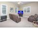Spacious bonus room featuring natural light, a large TV, plush carpeting, and recliner seating at 155 Culpeze Rd, Mooresville, NC 28117