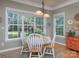 Bright breakfast nook with many windows, hardwood floors and views of the lush backyard at 155 Culpeze Rd, Mooresville, NC 28117