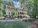 Charming two-story home with a landscaped yard and a mix of stone and beige siding at 155 Culpeze Rd, Mooresville, NC 28117