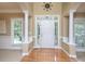 Grand foyer with hardwood floors, white columns, and a decorative light fixture above the front door at 155 Culpeze Rd, Mooresville, NC 28117