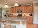 Spacious kitchen featuring granite countertops, stainless steel appliances, and warm wood cabinetry at 155 Culpeze Rd, Mooresville, NC 28117