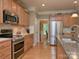 This spacious kitchen features granite countertops, stainless steel appliances, and warm wood cabinetry at 155 Culpeze Rd, Mooresville, NC 28117