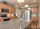 This kitchen has granite countertops, stainless steel appliances, and warm wood cabinetry at 155 Culpeze Rd, Mooresville, NC 28117