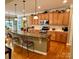 Spacious kitchen with wooden cabinets, granite countertops, a center island, and hardwood floors at 155 Culpeze Rd, Mooresville, NC 28117