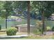 Picturesque lake view featuring a covered dock and lush greenery in the background at 155 Culpeze Rd, Mooresville, NC 28117