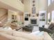 Spacious living room with a cozy fireplace, built-in shelves and soaring ceilings at 155 Culpeze Rd, Mooresville, NC 28117