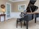 Cozy living room with a piano, a round side table, and natural light from the window at 155 Culpeze Rd, Mooresville, NC 28117