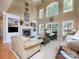 Bright living room featuring a fireplace, built-in shelves, and large windows offering plenty of natural light at 155 Culpeze Rd, Mooresville, NC 28117